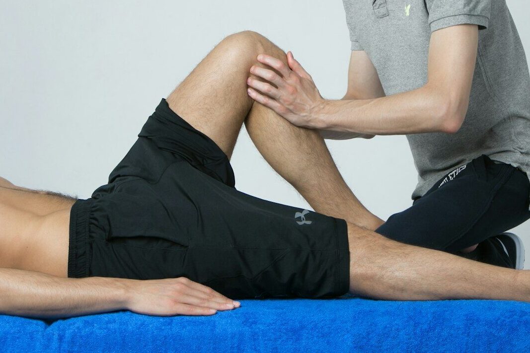 a man getting his leg examined by a doctor